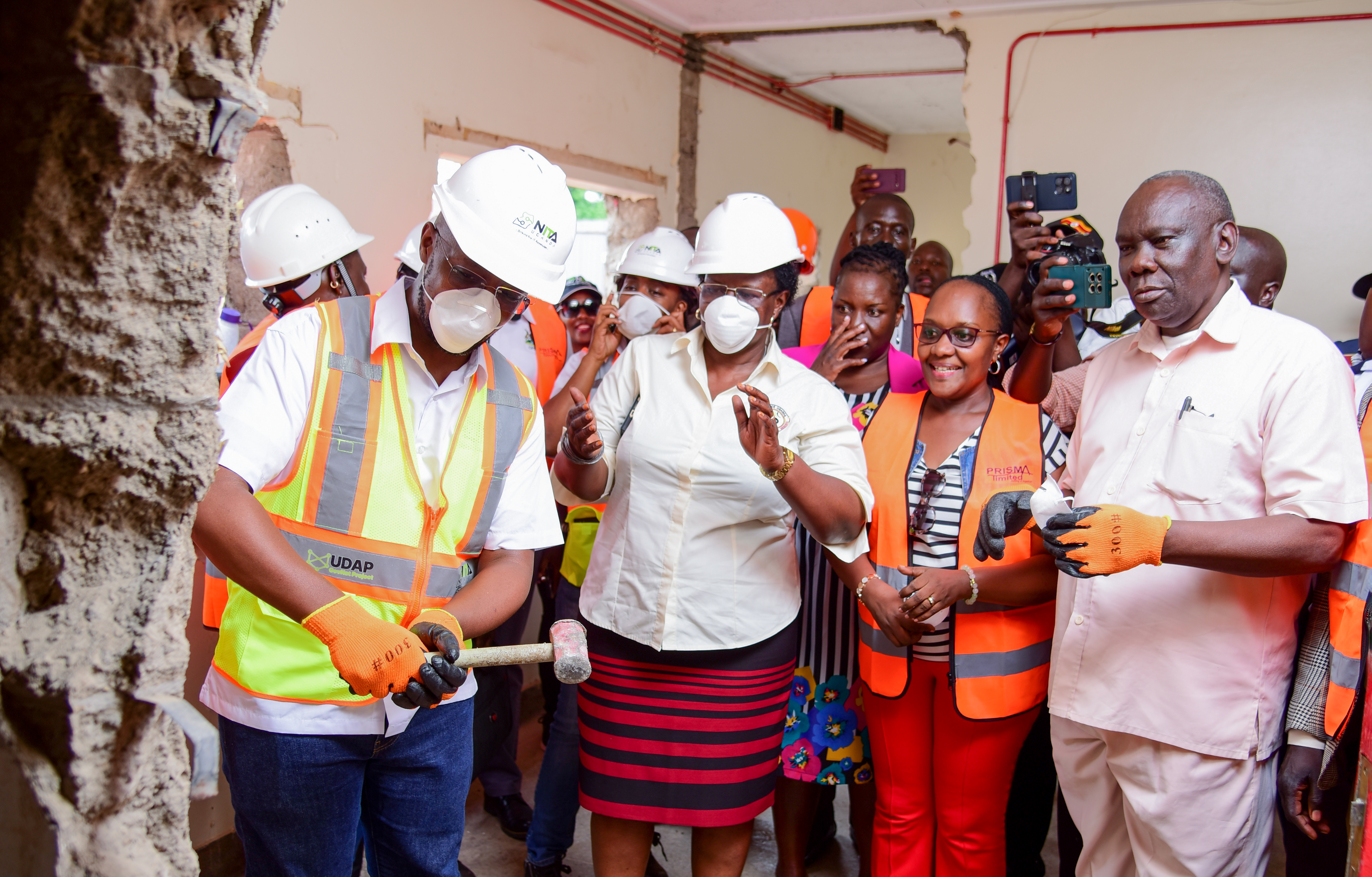 Dr. Mugasa performs the groundbreaking with a ceremonial hammer strike